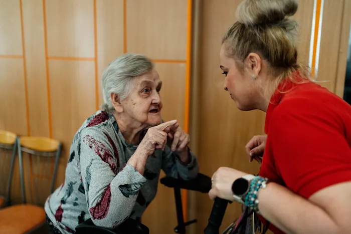 A care worker speaking with an older person