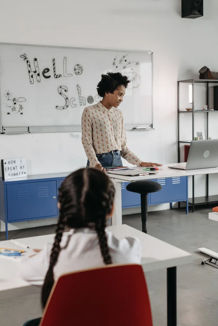 A teacher at a classroom whiteboard